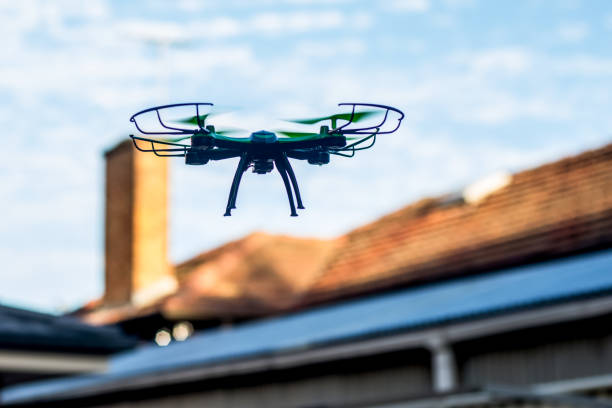 Drone quad copter flying over the roofs. Drone photography and videography. Toy drone flight. Copy space