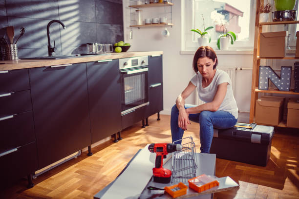 Worried woman sitting on a toolbox during DIY Renovations