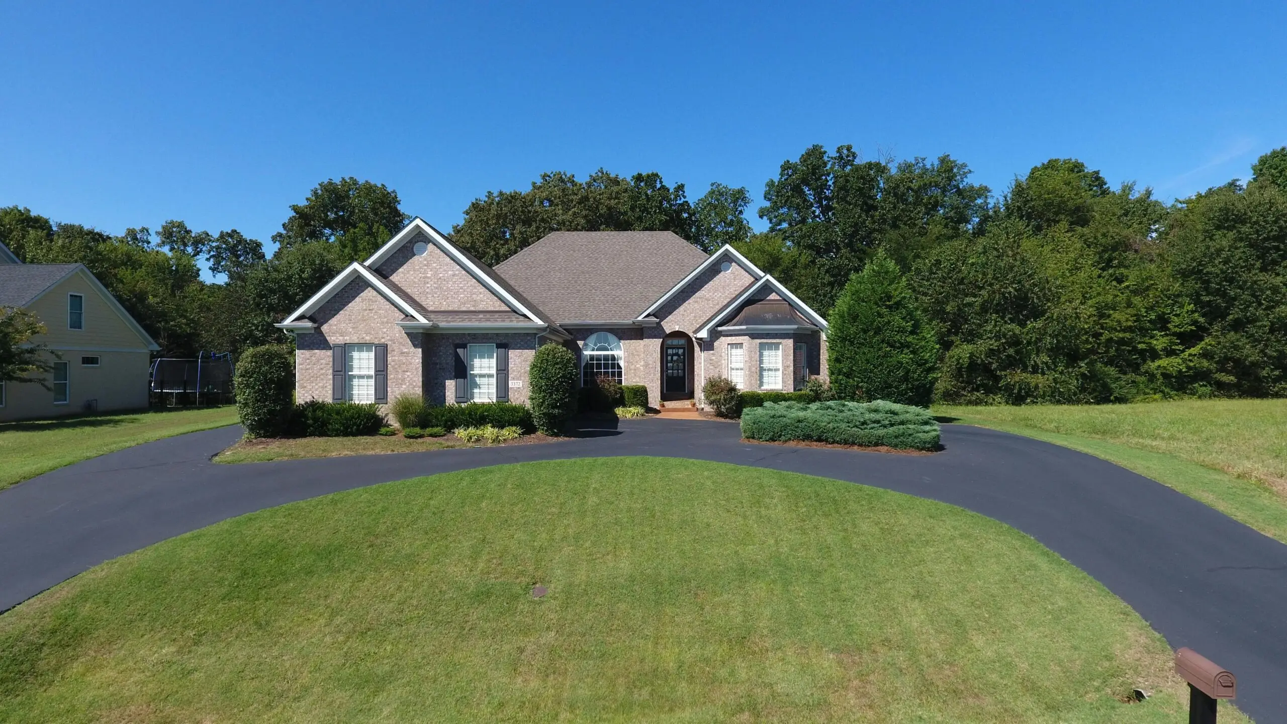 A large house with a lawn in front of it