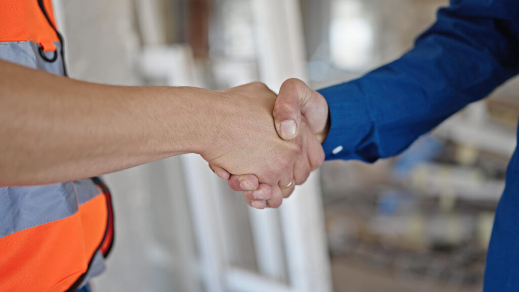 close up of contractor shaking hands with homeowner