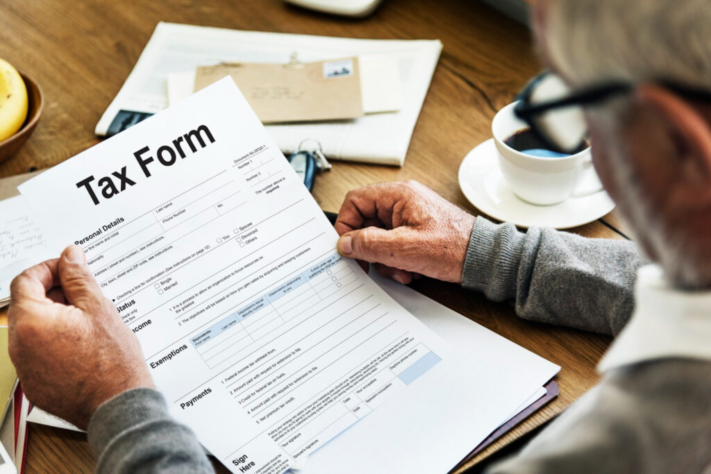 man holding a tax form looking for ways to make his home renovation tax deductible