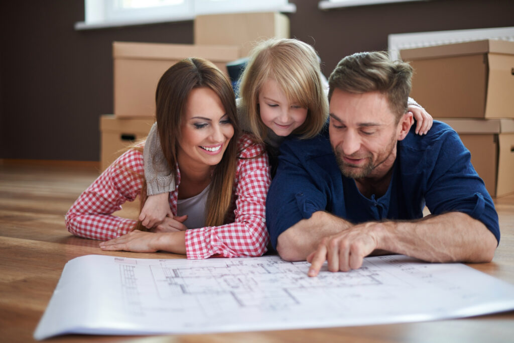A young family looking at floor plans together