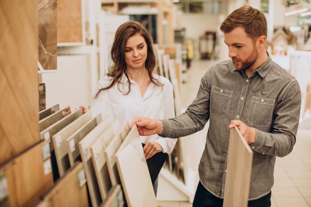 New homeowners reviewing flooring samples at a design showroom